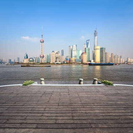 beautiful shanghai skyline in afternoon with wooden floor
