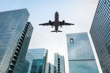 upward view of the airplane with modern office buildings
の写真素材