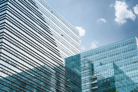 modern glass skyscraper under the blue sky ,blue curtain wall with abstract space