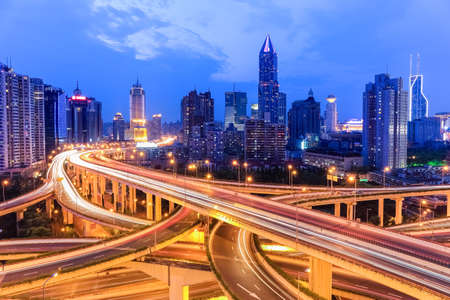 shanghai highway overpass with modern city skyline in nightfallの写真素材