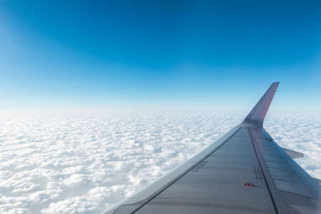 wing of the plane above the cloudsの写真素材