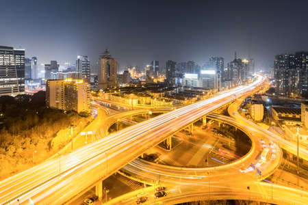 urban grade separation bridge in shanghai at busy nightの写真素材