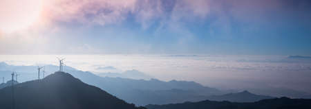 wind turbines in the morning and stretches of blue mountains background ,panoramic viewの写真素材