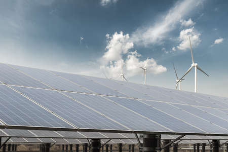 clean energy against a blue sky, solar power plant and wind farmの写真素材