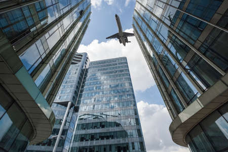 modern glass building and airplane, upward viewのeditorial素材