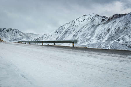 empty road with snow covered landscape in tibet plateauの写真素材