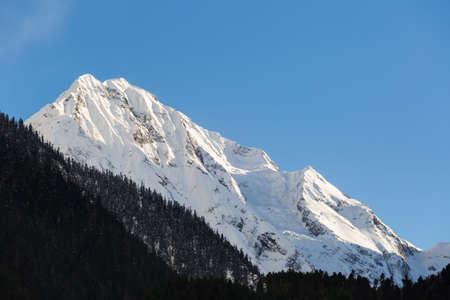 the snow capped mountains in bome , tibet