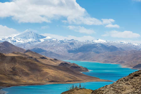 overlook snow mountain and holy lake in tibetの写真素材