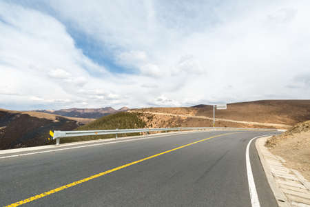 empty asphalt road with blue sky on tibet plateau, upward slope