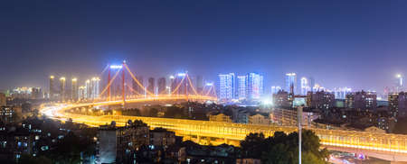 suspension bridge panorama at night in wuhan, Chinaの写真素材