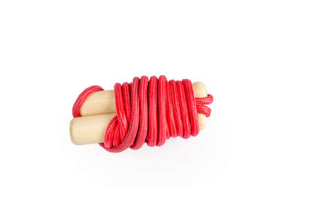 red skipping rope with wooden handles isolated on whiteの写真素材