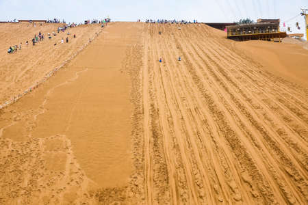 sliding sand, desert tourism in ningxia shapotou national nature reserve, Chinaのeditorial素材