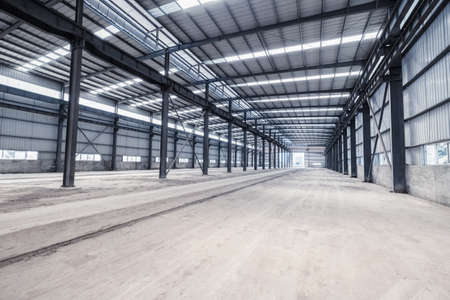 empty steel structure workshop, abandoned factory buildings or warehouseの写真素材
