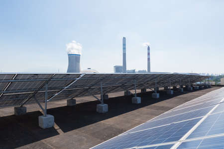 roof solar panels and thermal power plant , new energy and traditional coal-fired power generationの写真素材