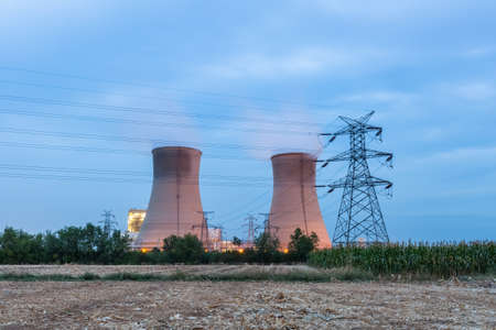 cooling water tower closeup on the farmland, thermal power plant in nightfall