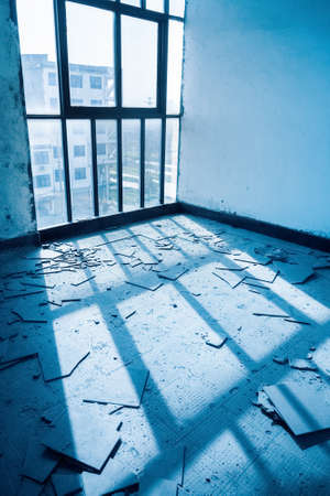 abandoned room with broken floor tilesの写真素材