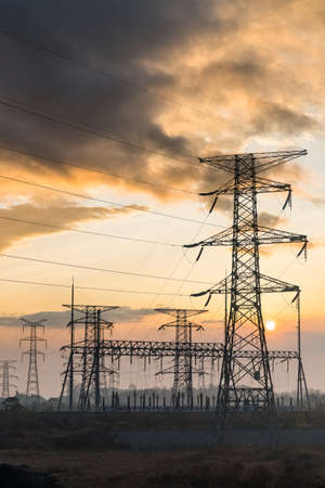 electricity transmission pylon at dusk, electric substation in sunset
