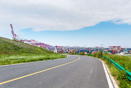 asphalt road and shipping container terminal in shanghaiの写真素材