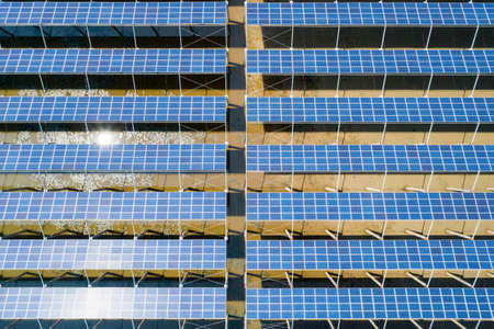 aerial view of solar power panels in clean energy generating stationの写真素材
