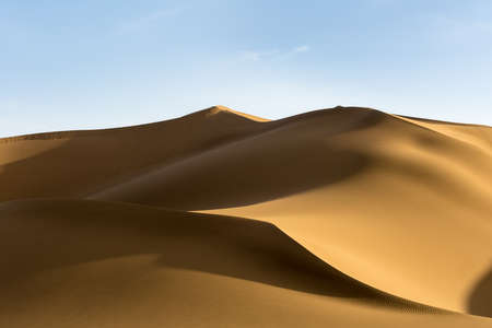 sand dunes, the setting sun shone over the desertの写真素材