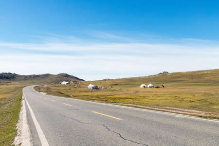 road in the steppe and nomadic background, xinjiangの写真素材
