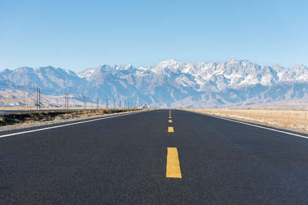 highway and snow mountain, road through the grand canyon, xinjiang anjihai