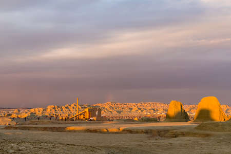 sunset shines on the oil field operation area , beautiful xinjiang ghost town,wind erosion landforms landscapeのeditorial素材