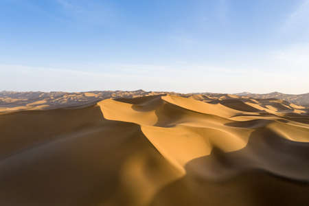 desert dusk landscape, setting sun shine over the dunesの写真素材