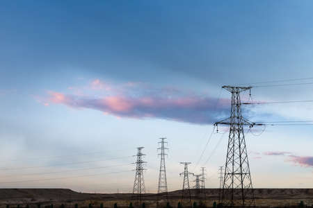 Transmission towers on wilderness at duskの写真素材
