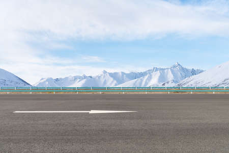 empty asphalt highway and snow mountain background