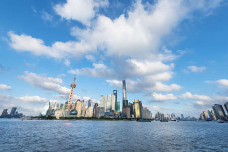 shanghai skyline with huangpu river against a sunny sky, China