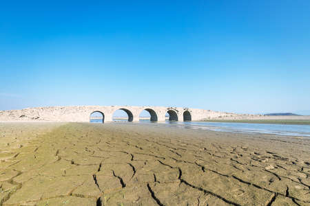 ancient stone arch bridge against a blue sky, hukou county, jiangxi province, China.の写真素材