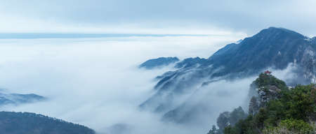 panoramic view of misty landscape at mount lu, watching clouds pavilion and cloud fog background, Chinaの写真素材