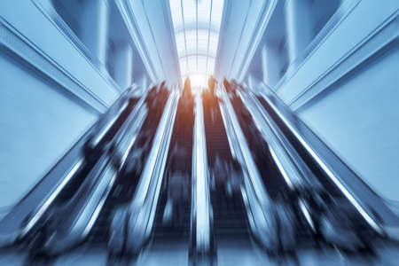 modern escalators with passengers motion blur in hankou railway station hall, wuhan city, Chinaの写真素材