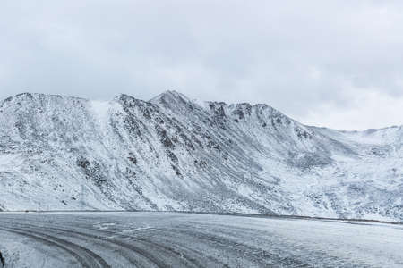 road in winter , highway turning and snowy mountain background