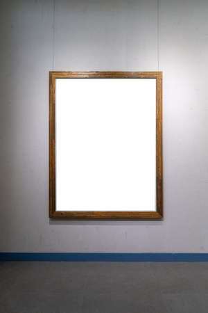 blank wooden picture frame isolated on old wallの写真素材