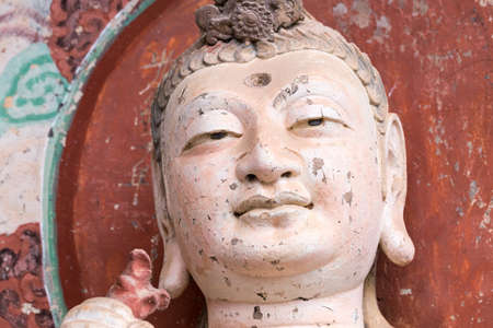 smiling buddha closeup in maiji mountain grottoes, tianshui city, gansu province, Chinaのeditorial素材