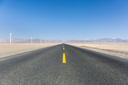 straight road through the wind farm on desert wilderness, qinghai province, Chinaの写真素材