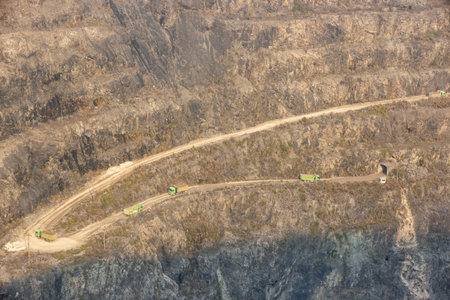 iron mine pit scene, truck drives along a winding path, huangshi national mine park, hubei province, Chinaの写真素材