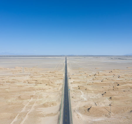 straight road through the wind erosion physiognomy, aerial view of yardang landscape in tsaidam basin, qinghai province, China.の写真素材