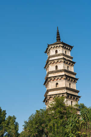 ancient tower closeup against a blue sky, jiujiang city, jiangxi province, Chinaの写真素材