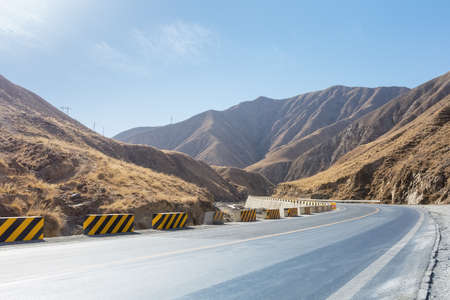 winding road in the autumn plateau, qinghai province, Chinaの写真素材