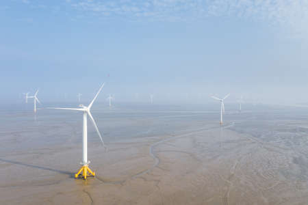 aerial view of wind farm on mud flats wetland, clean energy landscape, jiangsu province, China.の写真素材