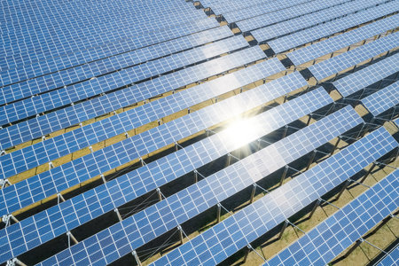 blue photovoltaic panels in sunlight, aerial view of renewable energy of solar power plantの写真素材