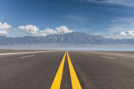 beautiful highway view, road by the lake with western wilderness landscapeの写真素材