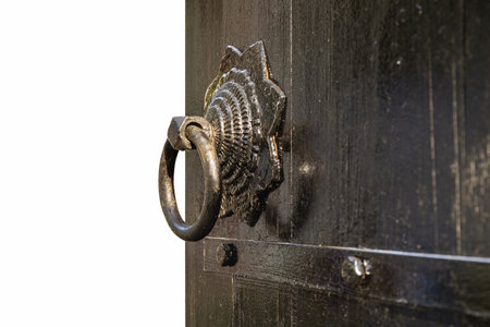 an old black wooden door and knocker isolated on white with clipping pathの写真素材
