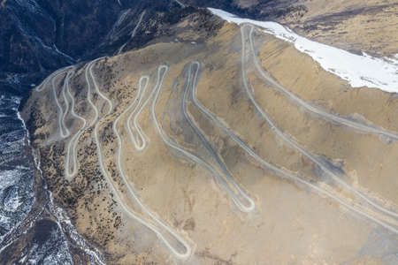 aerial view of the rough road, winding mountain road in Banbar county, Qamdo city, Tibet autonomous region, Chinaの写真素材