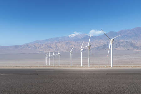 road and wind energy on western wilderness, qinghai province, Chinaの写真素材