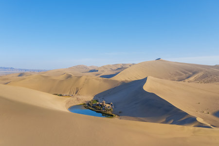 beautiful crescent lake in singing sands mountain, desert wonders on Dunhuang city, Gansu province, China.の写真素材