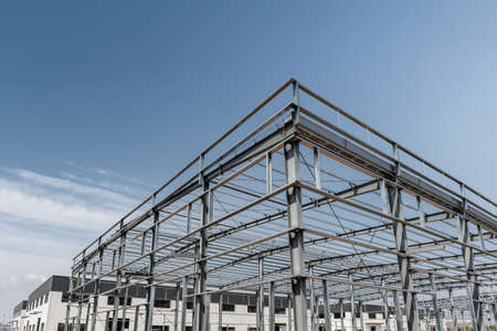 steel frame mill plant, steel structure workshop against a blue skyの写真素材